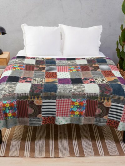 Photo d'une couverture imprimé de patchwork graphique sur un lit.