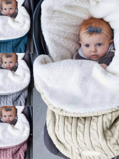 Photo d'un bébé dans une couverture de poussette en tricot polaire.