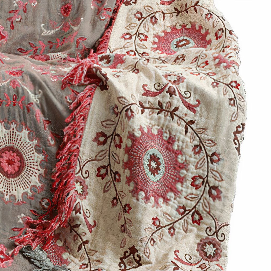 Couverture en fil tricoté avec un motif fleurs posée sur un canapé