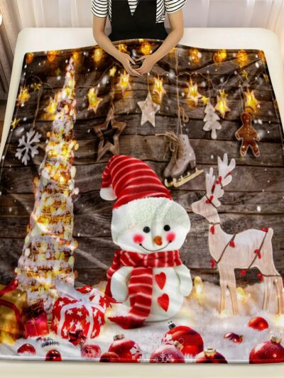 Couverture de Noël en Tissu Microfibre avec Imprimé d'un Bonhomme de Neige sur un lit avec une personne dedans